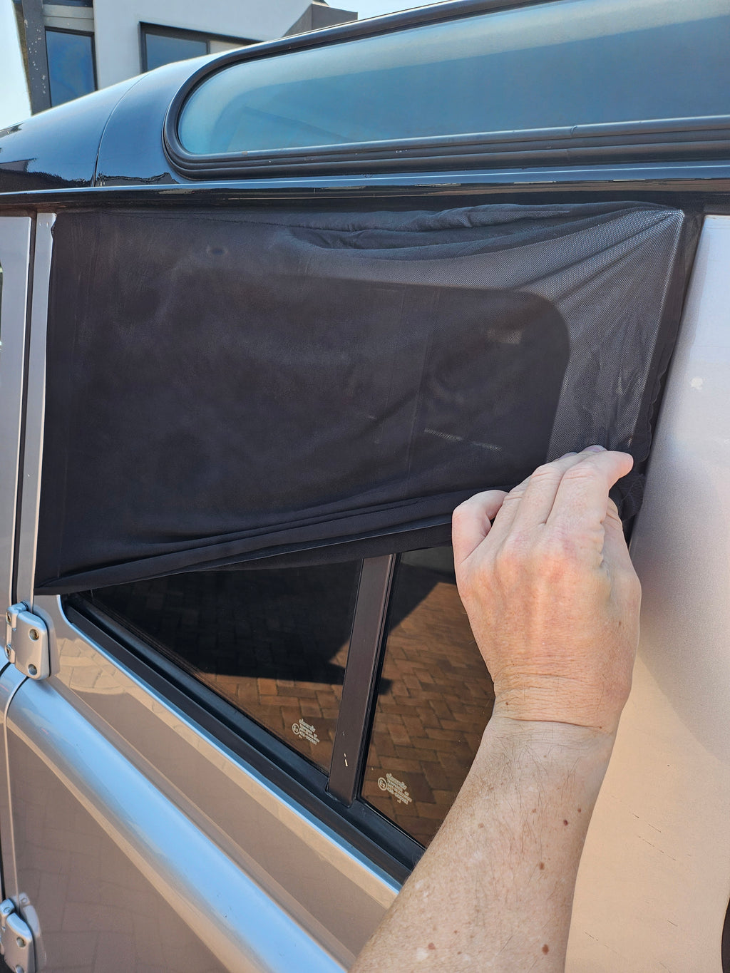Fitting a MotoFeli sun shade sock over a car door window frame